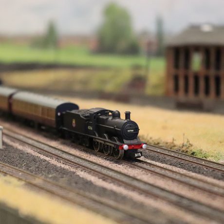 A close up of a model train on a track.