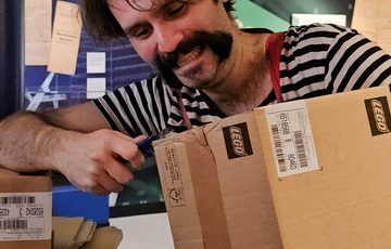 A person working with a cardboard box.