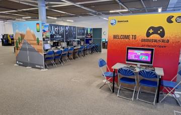 Inside Gamesworld with rows of computers and chairs.