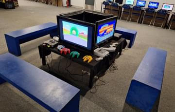 A square of 4 computer games sections with benches.