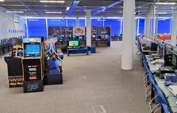 Inside of Gamesworld with rows of chairs and computers.