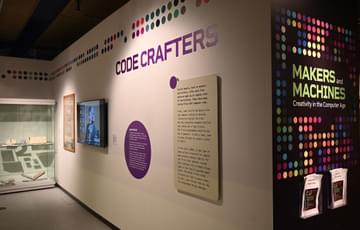 A display wall with TV screen on it and the heading 'Code Crafters'.