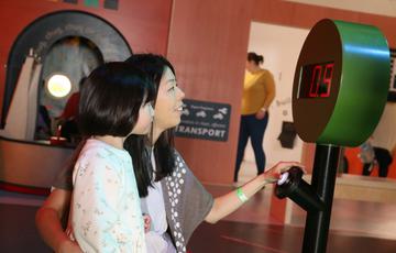 An adult and child pressing a larger timer button.