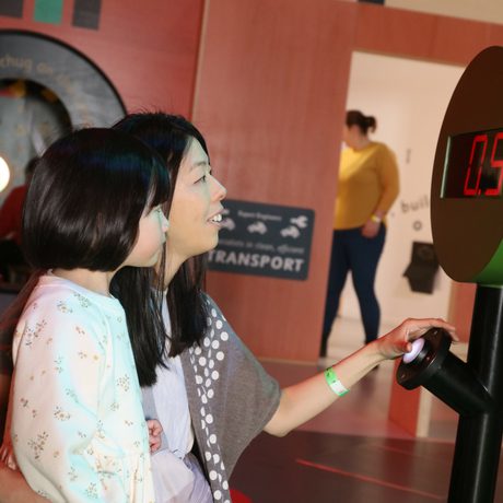 An adult and child pressing a larger timer button.