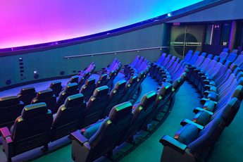 Seats in an empty planetarium.