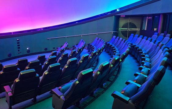 Seats in an empty planetarium.