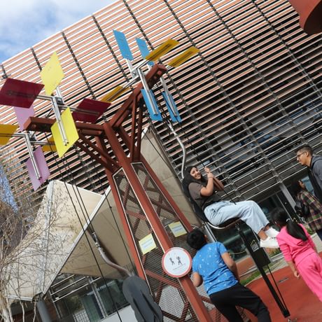 An adult pulling themselves up on the interactive pulley.