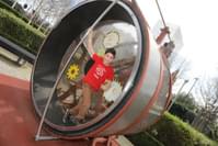 A child on a giant human sized hamster wheel.
