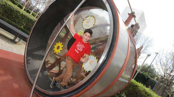 A child on a giant human sized hamster wheel.