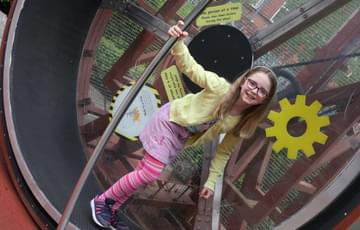 A child in a giant hamster wheel.