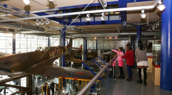 Family looking at a Spitfire plane suspended in the air.