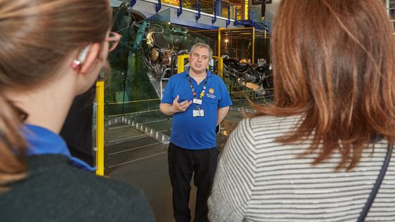 A staff member talking to two people