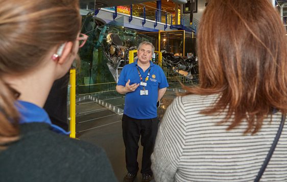 A staff member talking to two people