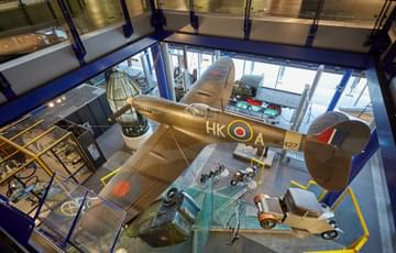 A military airplane hanging from the ceiling at Thinktank.