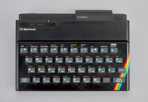 A black computer keyboard with a rainbow in corner.