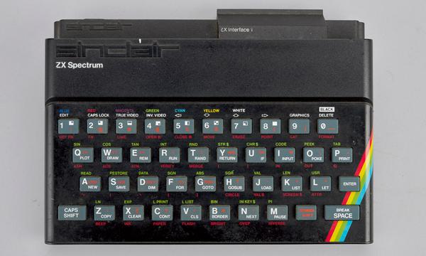 A black computer keyboard with a rainbow in corner.