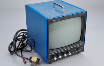 A blue computer monitor with leads attached.