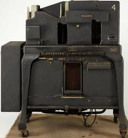 A large dark machine standing on four legs.