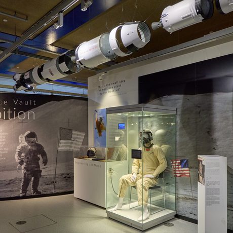Wide angle view of the exhibition with introduction panel, space suit and large photo graphics.