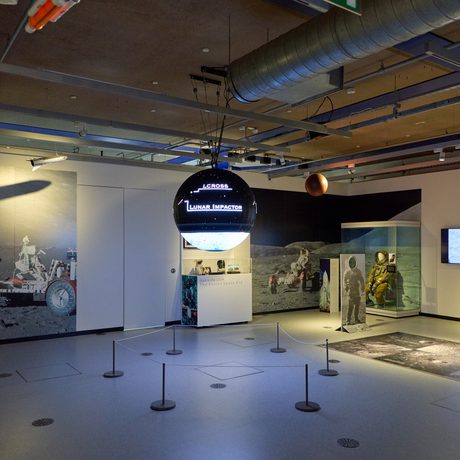 A display with sphere screen and display cases around.