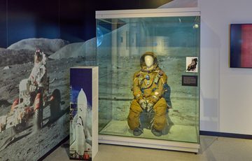 A spacesuit in a display case.