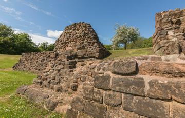 Close up of ruined stone Castle walls and a cherry tree in blossom