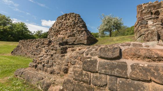 Close up of ruined stone Castle walls and a cherry tree in blossom