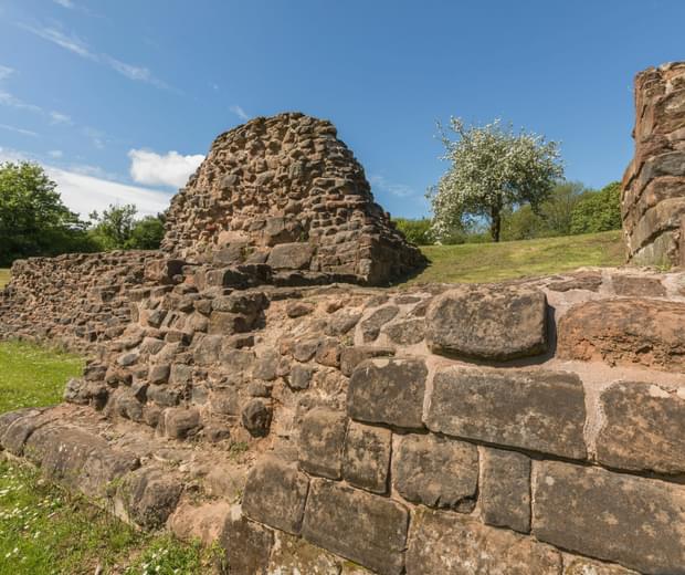 Close up of ruined stone Castle walls and a cherry tree in blossom