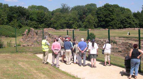 A group of people viewing Weoley Castle ruins
