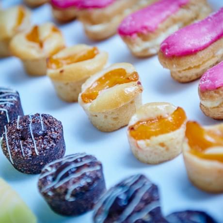 Close up of colourful desserts on a tray.
